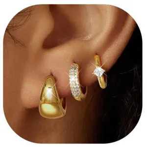 Macro detail of gold-plated hoop earring set with zircon inlays and starburst shimmer
