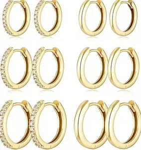 Detail of 18k gold plated hoop earrings set with crystal inlay and polished finishes