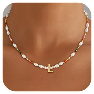 Detail of beaded necklace with colorful beads and gold brass initial L pendant