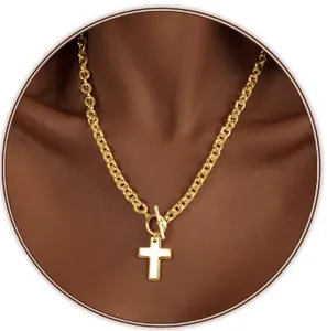 Gold chunky chain necklace with cross pendant and T-bar toggle clasp on model