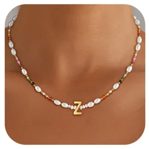 Detail of beaded necklace with Baroque pearls and colorful beads featuring a gold letter Z
