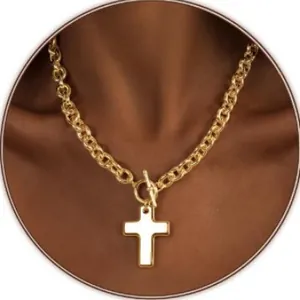 Gold chunky chain necklace with a cross pendant and toggle clasp on a model