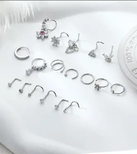 Macro shot of 15pcs silver nose rings set with cubic zirconia and heart charms