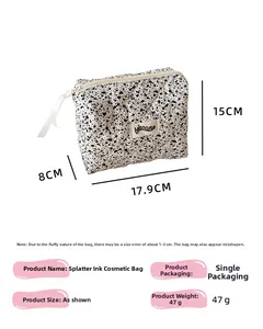 Quilted ink splatter makeup bag with dimensions 17.9cm x 15cm x 8cm and isocute label