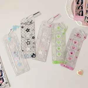 Close-up of glitter PVC photo holders with cute prints and metal bead chains