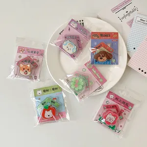 Detail view of cute dog and cat acrylic fridge magnets with clips in gift packaging