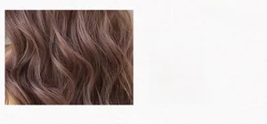 Detailed texture of wavy long hair wig in soft pinkish brown color with natural curls