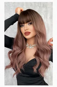 Close-up of long wavy ombre pink brown wig with blunt bangs and voluminous curls