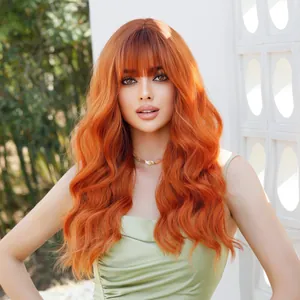 Long wavy orange ginger wig with blunt bangs shown on a model in outdoor natural light