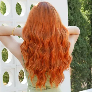 Long wavy ginger orange wig for women with natural curls and vibrant copper tones