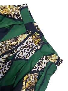 Detail of elastic pleated waist and vibrant paisley leopard print on wide leg trousers