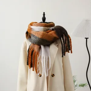 Close-up of thick checkered scarf with long tassels showing soft mohair texture