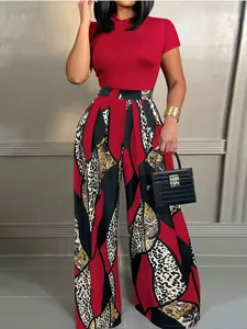 Detail of red short sleeve top paired with high waist leopard print wide leg trousers