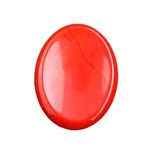 Polished oval red turquoise thumb stone with black veins for healing and crystal therapy
