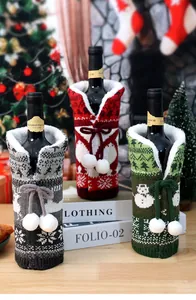 Detail of Christmas knitted wine bottle covers with faux fur trim and festive patterns
