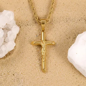 Macro shot of gold-plated crucifix pendant necklace with a detailed rope chain design
