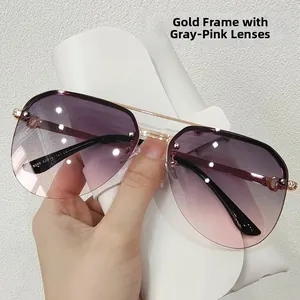 Detail of aviator sunglasses with gold frame, gradient grey pink lenses and C-shaped hinge