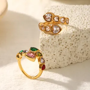 Polished stainless steel heart rings with colorful zircon inlays on white stone