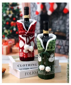 Detail of red snowflake and green snowman knitted wine bottle covers with plush trim