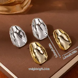Detail view of metallic flower stud earrings with size 2.5cm and weight 4g measurements