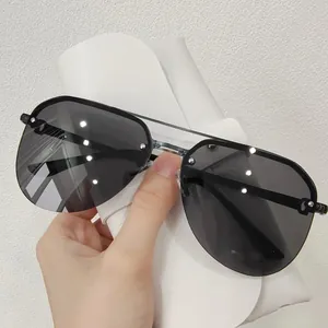 Fashion aviator sunglasses with black frames, grey lenses, and silver rivet accents