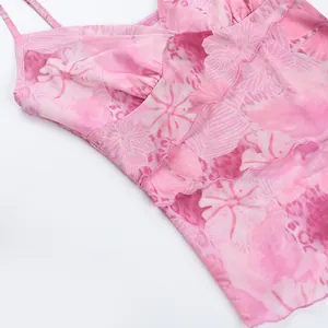 Detail of pink floral mesh top with adjustable spaghetti straps and ruffled trim