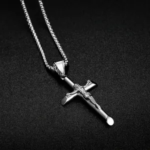 Polished silver stainless steel cross pendant necklace with box chain on black texture