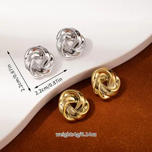 Detail view of gold and silver knot stud earrings showing size dimensions and weight
