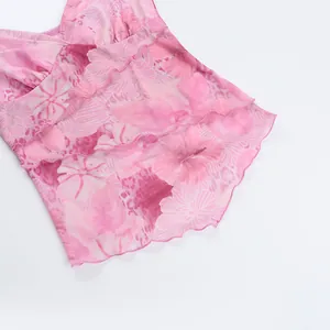 Detail of pink floral mesh top with layered ruffle trim and hibiscus flower print