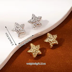 Detail of star-shaped earrings with textured finish in gold and silver plating