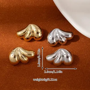 Close-up of metallic flower petal earrings in gold and silver finish with size markings