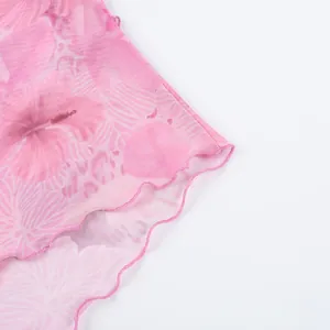 Close-up of pink floral mesh fabric with delicate lettuce edge hem detailing