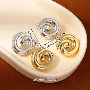 Detail view of gold and silver spiral flower earrings with size and weight dimensions