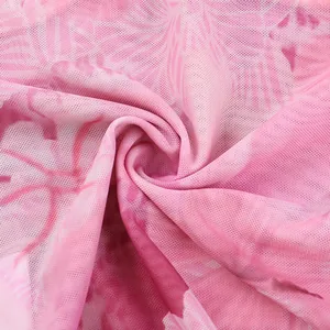 Close-up of pink floral mesh fabric with a breathable semi-transparent texture and soft print