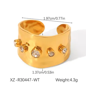 Detailed view of golden hammered ring with zircon inlays and product dimensions