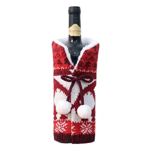 Knitted Christmas wine bottle cover with reindeer snowflakes and white pom-poms decor