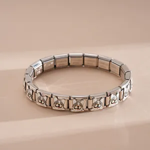 Close-up of stainless steel charm bracelet featuring a cute enamel French Bulldog pattern