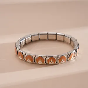 Macro detail of stainless steel links with Beagle dog enamel charms on a modular bracelet