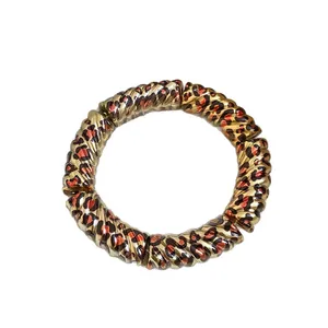 Minimalist leopard print circular bracelet with a twisted spiral texture in gold finish