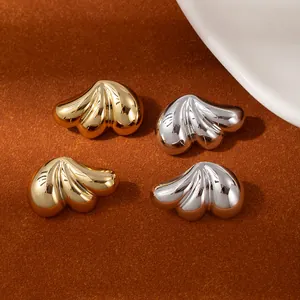 Detail of layered gold and silver flower petal earrings with a high-shine mirror finish