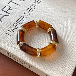 Amber acrylic beaded bracelet with gold metal ring accents in vintage style