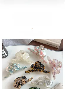 Macro view of assorted bow-shaped acetate hair claws in various marble and tortoiseshell patterns