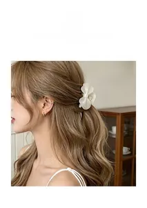 Elegant white acetate flower hair claw clip securing a half-up style on brunette hair