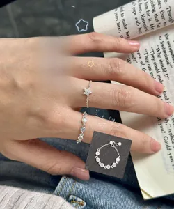 Detail of adjustable S925 sterling silver chain rings with star charms and zircon accents