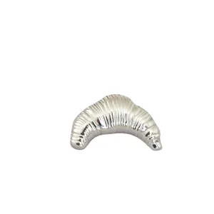 Sliver irregular croissant brooch with spiral metal texture on a white background