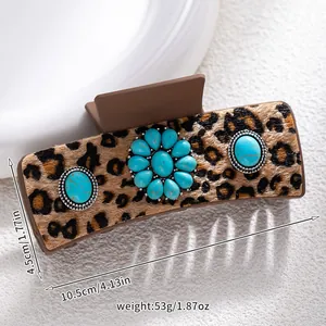 Detail of leopard print hair claw clip with turquoise inlays and 10.5cm size markings