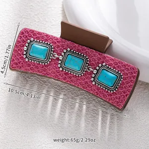 Detail of pink glitter hair claw with square turquoise stones and size markings