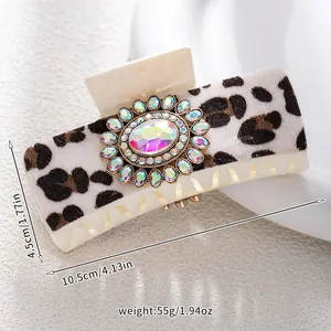 Detail of leopard print hair claw with turquoise stone and dimensions 10.5cm by 4.5cm