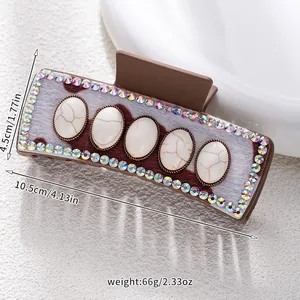 Detail of bohemian hair claw clip with faux fur, marble stones and size measurements