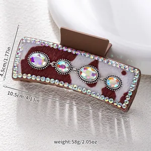 Detail of western style hair claw with cow print fur and large sparkling rhinestones